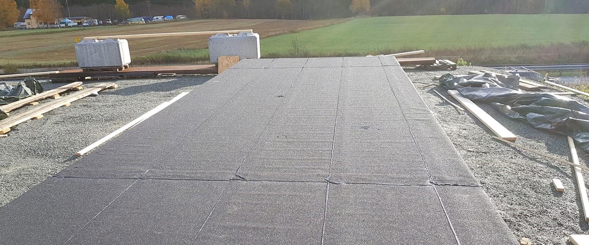 A large flat roof being laid on a building site