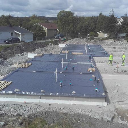 A foundation slab covered in membrane on a building site